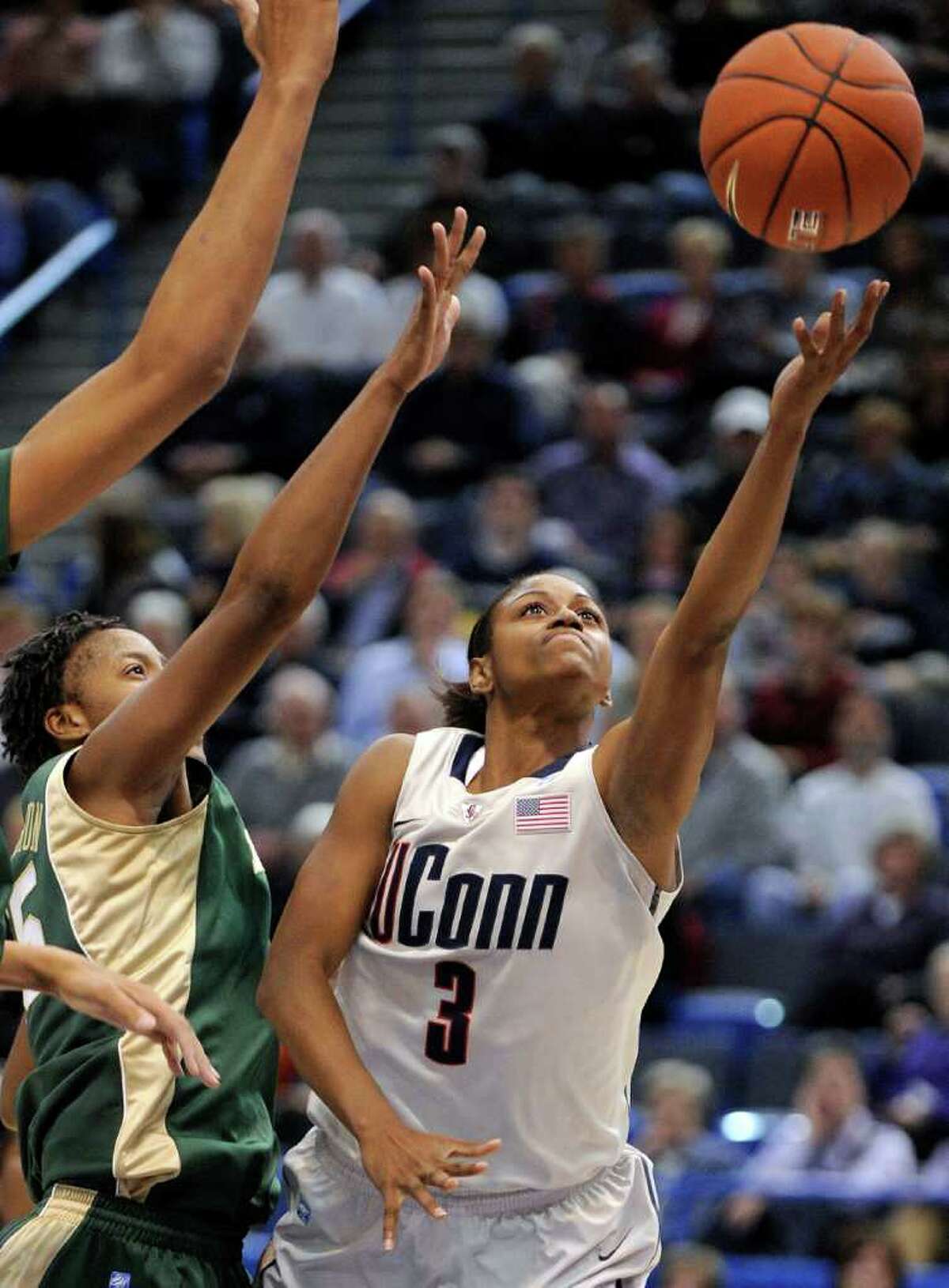 Connecticut's Tiffany Hayes, right, drives past Baylor's Shanay Washington during the first half of an NCAA college basketball game in Hartford, Conn., on Tuesday, Nov. 16, 2010. (AP Photo/Fred Beckham)