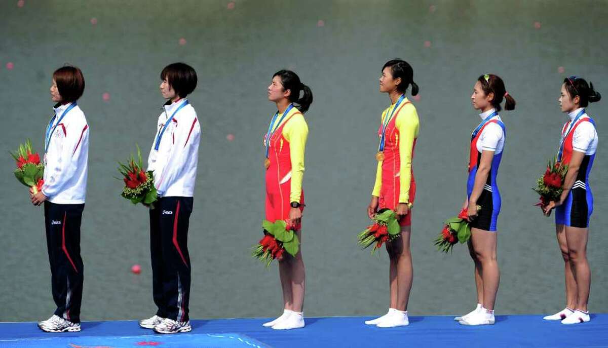 GUANGZHOU, CHINA - NOVEMBER 18: (L-R) Silver medallists Akiko Iwamoto and Atsumi Fukumoto of Japan , Gold medallists Wenyi Huang and Feihong Pan of China and Bronze medallists Myungshin Kim and Solji Kim of South Korea in the Lightweight Women's Double Sculls Final Race A during day six of the 16th Asian Games Guangzhou 2010 at International Rowing Centre on November 18, 2010 in Guangzhou, China. (Photo by Jamie McDonald/Getty Images) *** Local Caption *** Wenyi Huang;Feihong Pan;Akiko Iwamoto;Atsumi Fukumoto