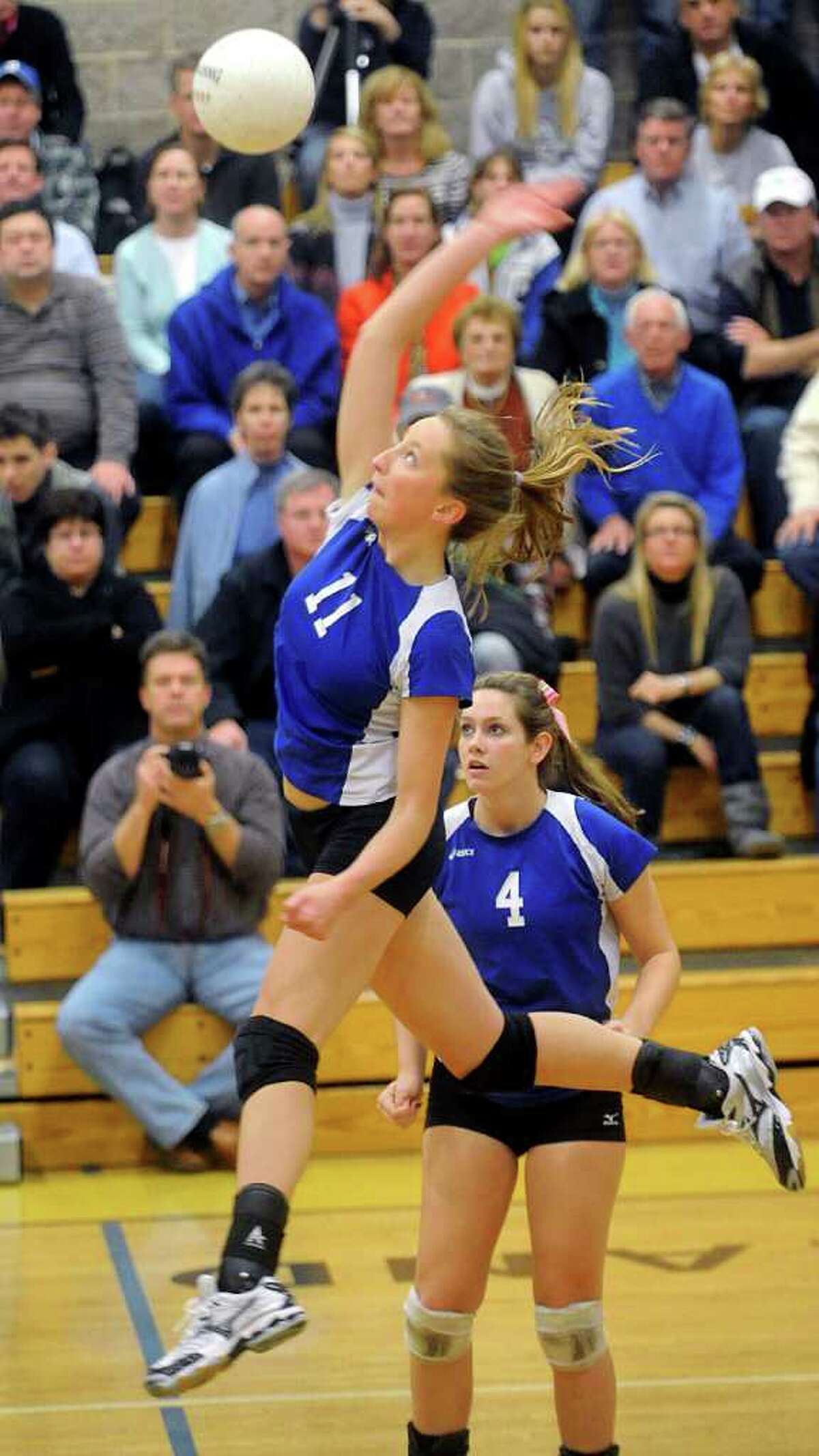 Darien's Katie Stueber spikes the ball during the Girls Volleyball State Tournament Class L Semifinal game against Farmington at Woodland High School on Thursday, November 18, 2010.