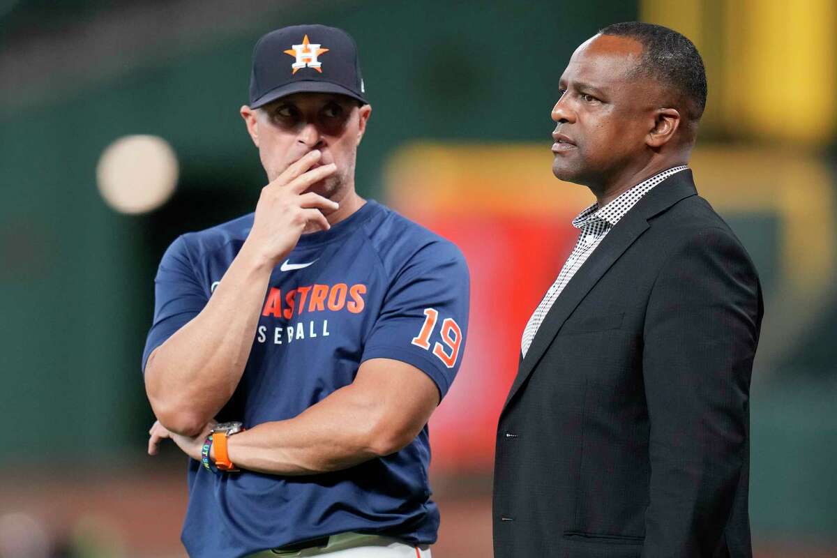 Houston Astros manager Joe Espada (19) speaks with general manager Dana Brown, right, during batting practice before a baseball game against the Philadelphia Phillies, Wednesday, June 25, 2025, in Houston. (AP Photo/Karen Warren)