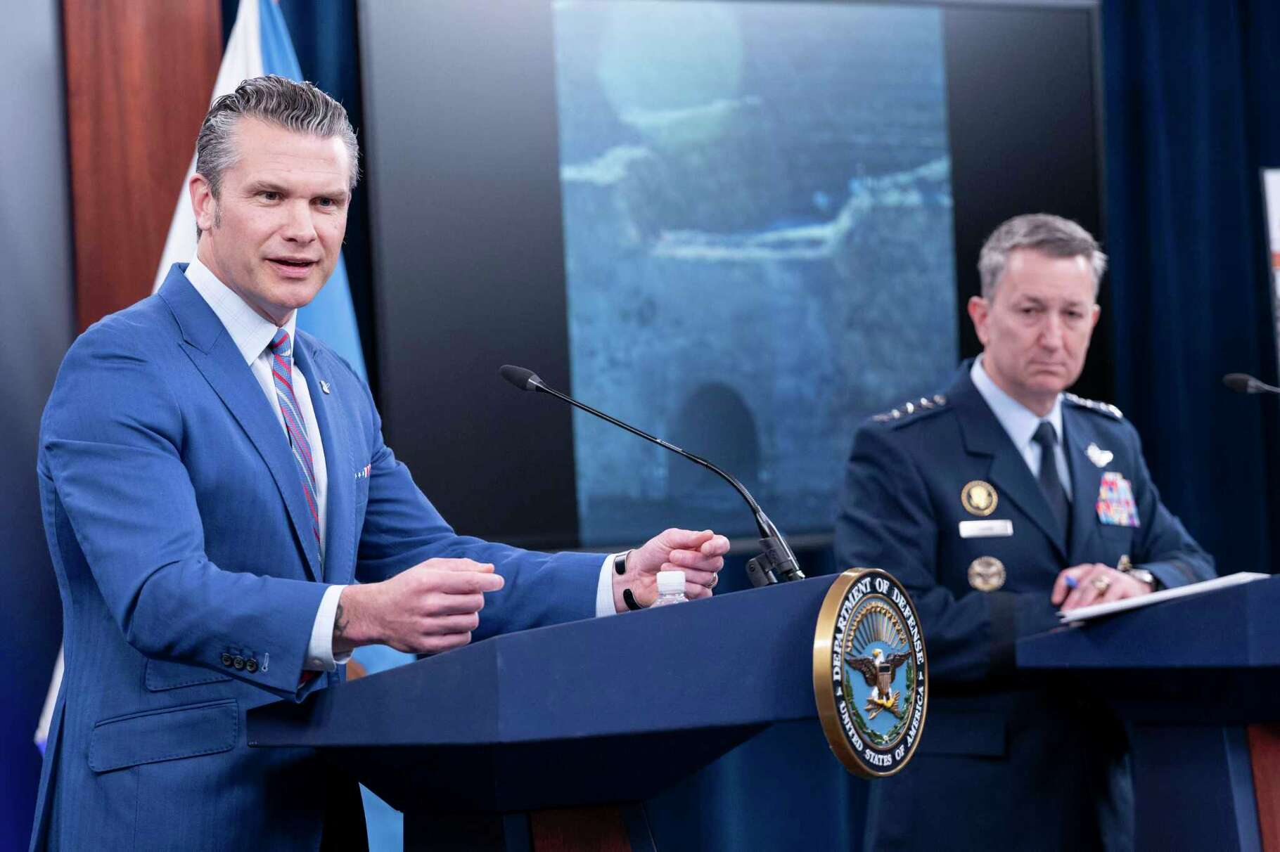 Defense Secretary Pete Hegseth, left, speaks at a news conference with Joint Chiefs Chairman Gen. Dan Caine at the Pentagon, Thursday, June 26, 2025 in Washington. (AP Photo/Kevin Wolf)