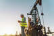 Onshore oil well area, gas drilling pad. Inspector on quality control. Gas and oil station