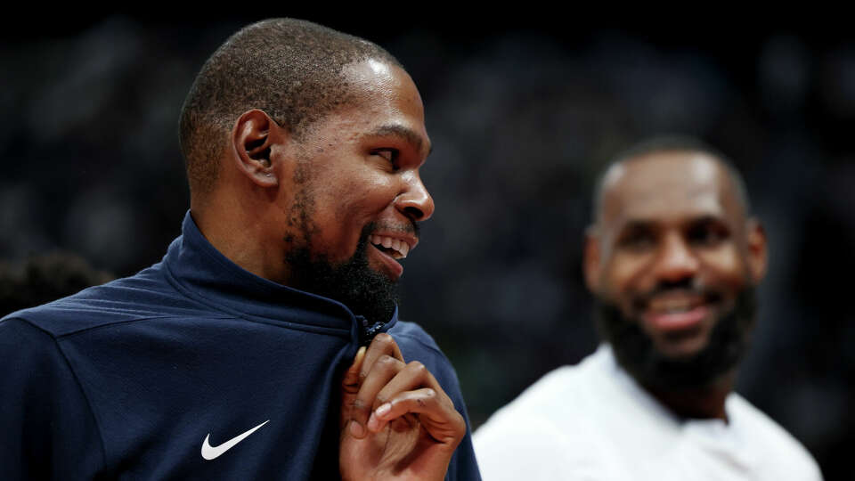 Kevin Durant (left) and LeBron James (right) of the United States during the second half of an exhibition game between the United States and Australia ahead of the Paris Olympic Games at Etihad Arena on July 15, 2024 in Abu Dhabi, United Arab Emirates. 