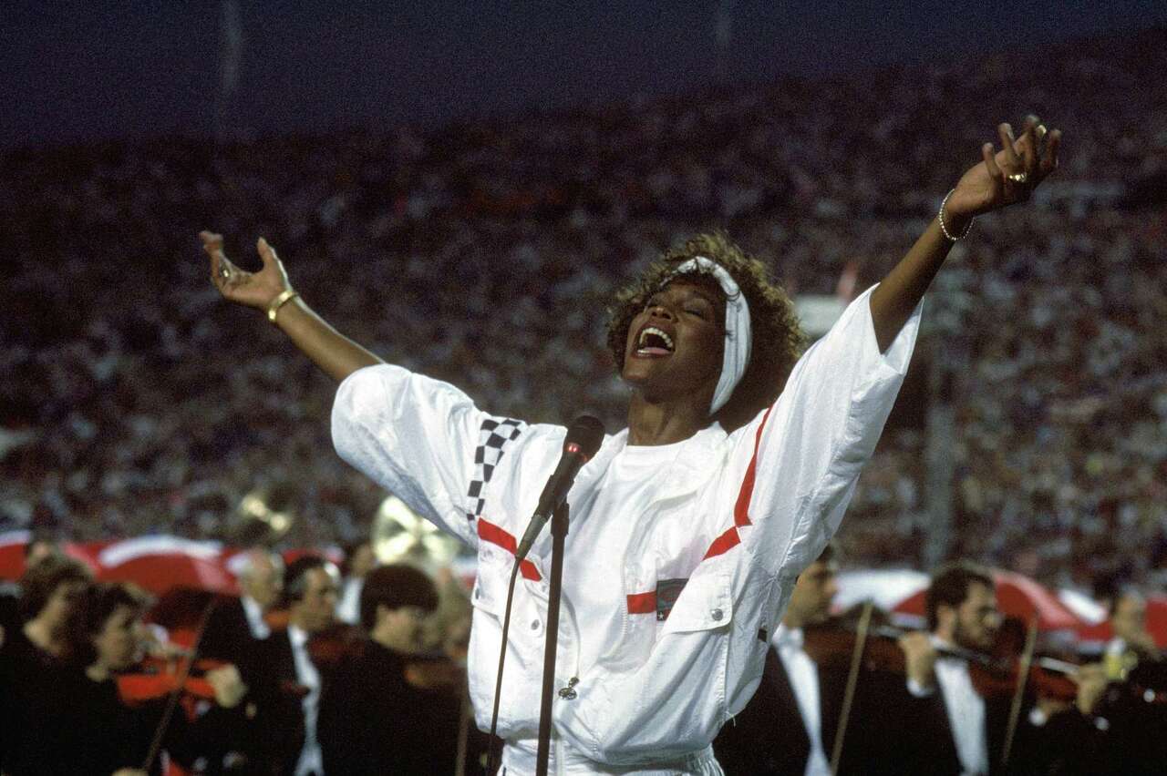 TAMPA, FL - JANUARY 27: Whitney Houston sings the National Anthem before a game with the New York Giants taking on the Buffalo Bills prior to Super Bowl XXV at Tampa Stadium on January 27, 1991 in Tampa, Florida. The Giants won 20-19.