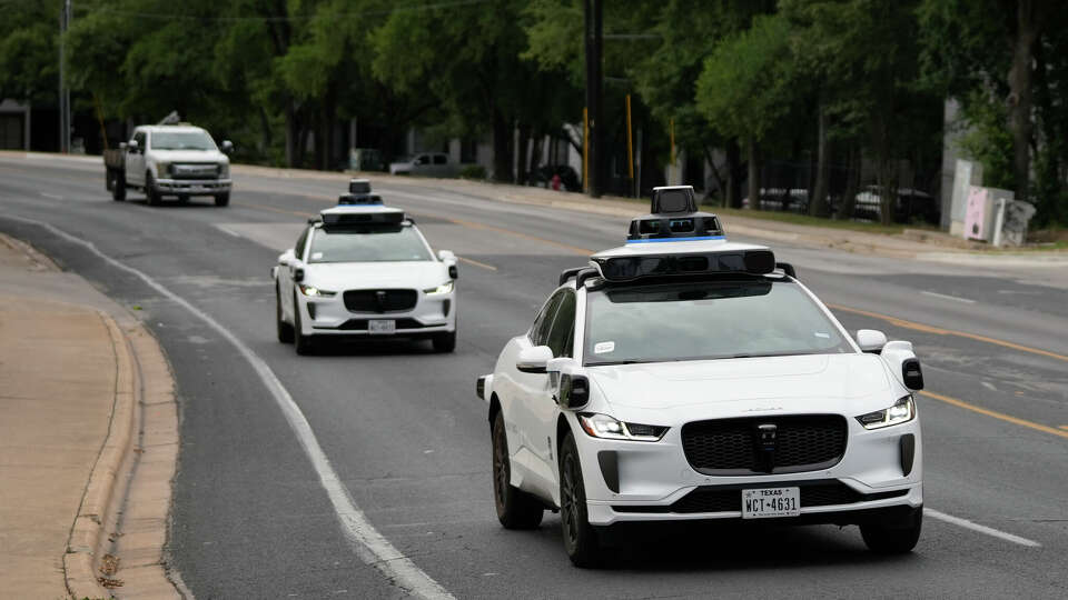 Waymo autonomous vehicles travel along East Oltorf Street in Austin on Tuesday, July 1.