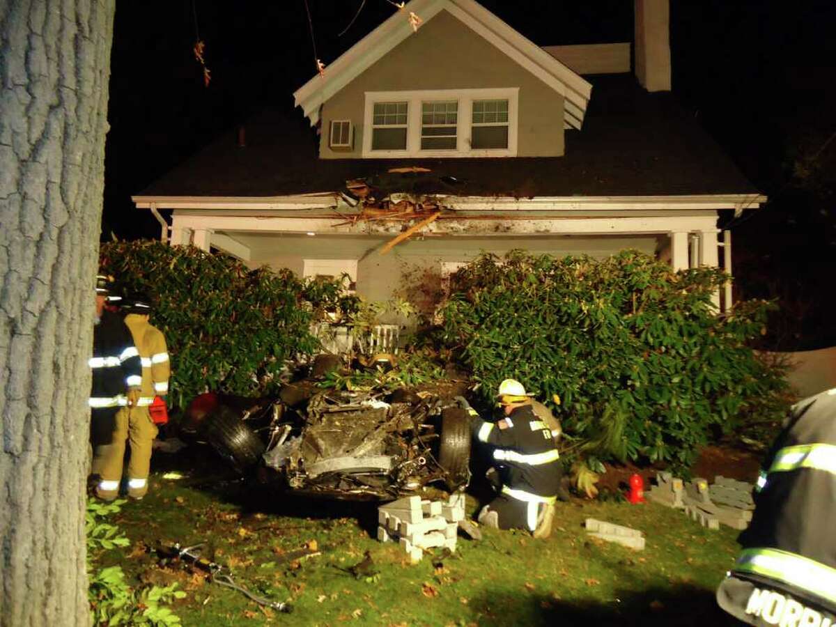 The driver of a Porsche Carrera was trapped for 40 minutes after going airborne for 35 feet and crashing into a house at 24 Highland Ave. in Rowayton late Friday night.