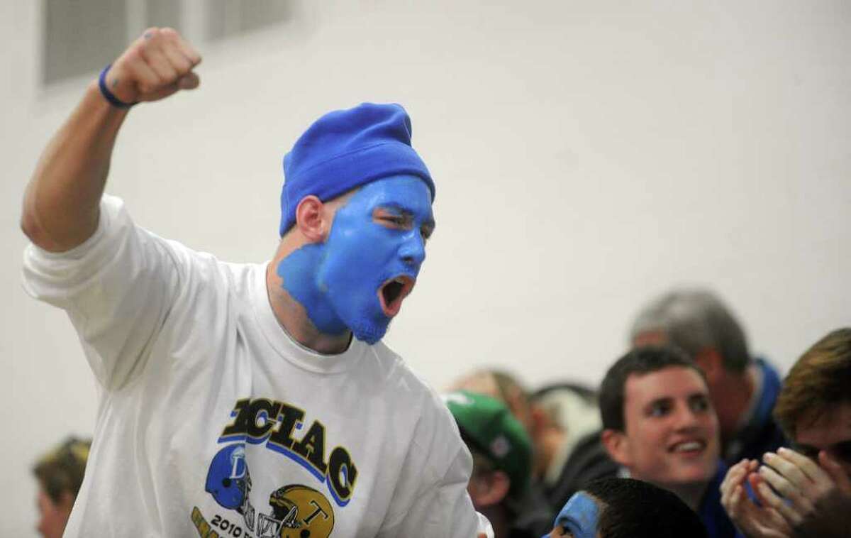 A painted Darien fan cheers for his team during Saturday's Class L Volleyball Championship game against East Lyme at Glastonbury High School on November 20, 2010.
