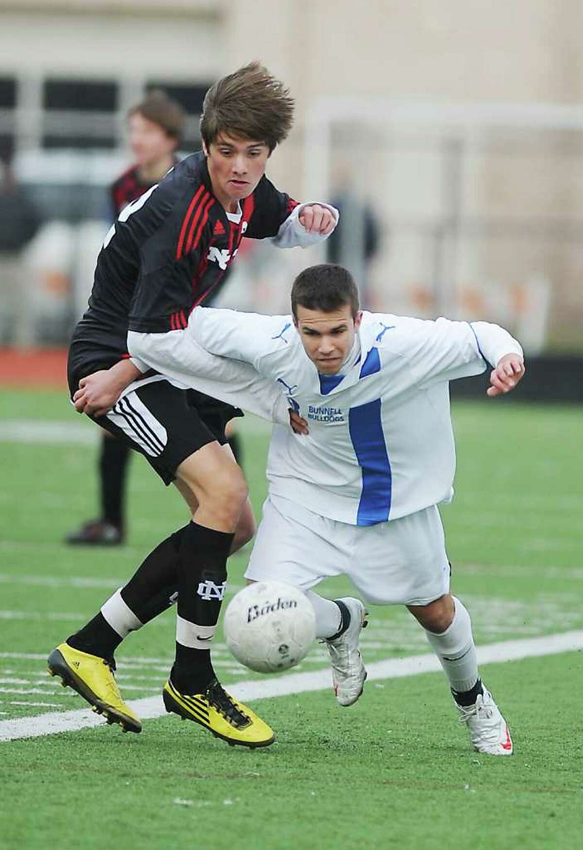 Bunnell's James Gillespie eyes the ball against New Canaan's Nicolas Deambrosio in the Class L boys soccer championship match at Fairfield Ludlowe High School in Fairfield, Conn. on Saturday November 20, 2010. New Canaan won the game 2-0.