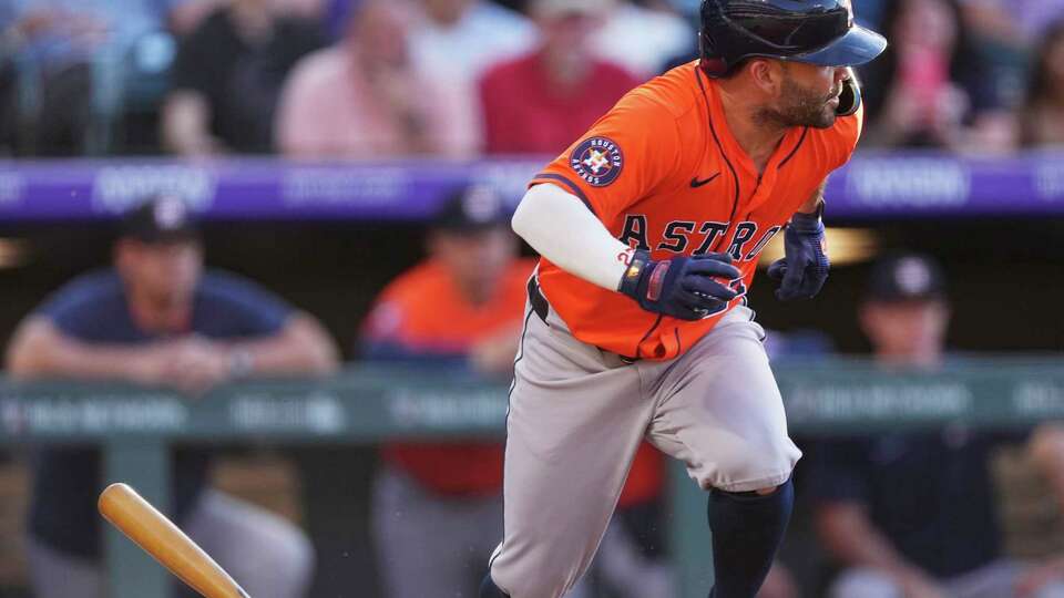 Houston Astros' Jose Altuve breaks from the batter's box after putting down a bunt single against Colorado Rockies starting pitcher Austin Gomber in the first inning of a baseball game Wednesday, July 2, 2025, in Denver. (AP Photo/David Zalubowski)