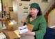 Debra Lynch, a nurse practitioner and founder of Her Safe Harbor, unboxes a shipment of abortion medications on Dec. 5, 2024, in the living room of her Delaware home. Operating under Delaware's shield law, Lynch prescribes abortion medications via telehealth, largely to patients in abortion-restricted states like Texas.