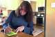 Nurse practitioner Debra Lynch writes a note to a patient on Dec. 6, 2024 from the kitchen table headquarters of Her Safe Harbor, a Delaware-based telehealth abortion provider. "We are here for you if you need us," Lynch wrote, encouraging the patient to reach out with any questions.