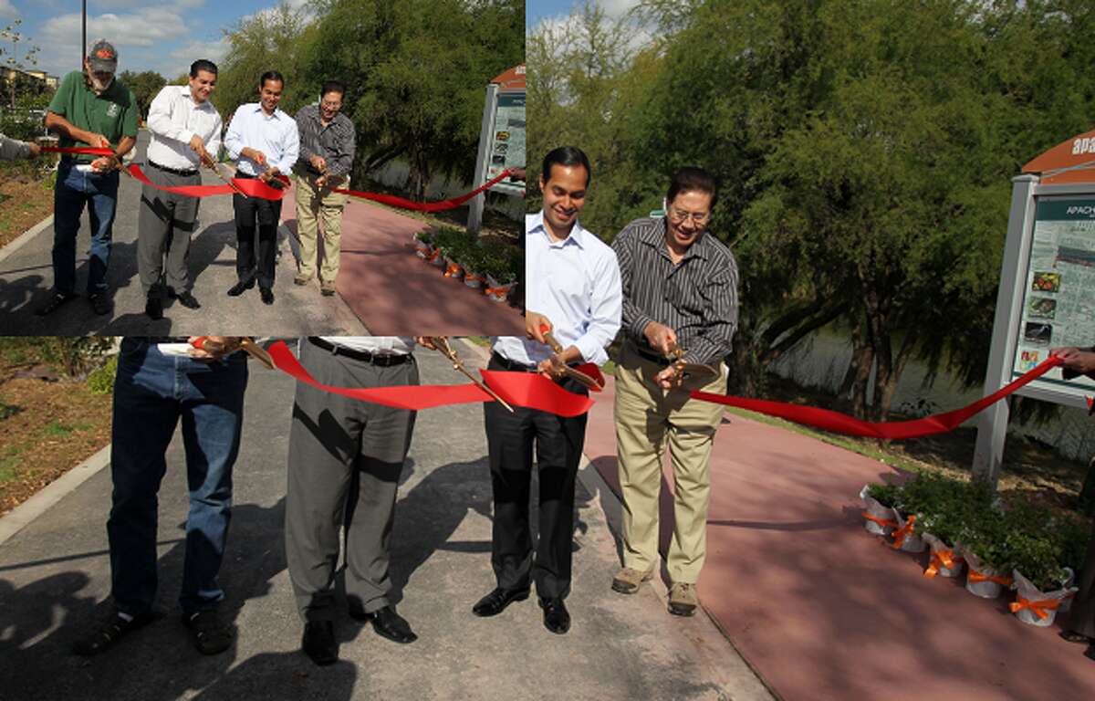 Rod Radle (from left), District 5 City Councilman David Medina, Mayor Julian Castro and Robert Rodriguez cut the ribbon to open the first trail on the West Side at the Dedication & Blessing of the Apache/Zarzamora Creeks Linear Park .