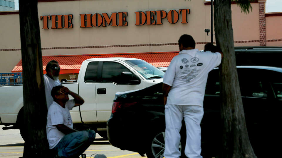 Day laborers wait for work in the shade in the parking lot of the Home Depot store Wednesday, June 19, 2019, in Houston. Known as jornaleros, these informal workers often have some of the lowest wages in the industry.