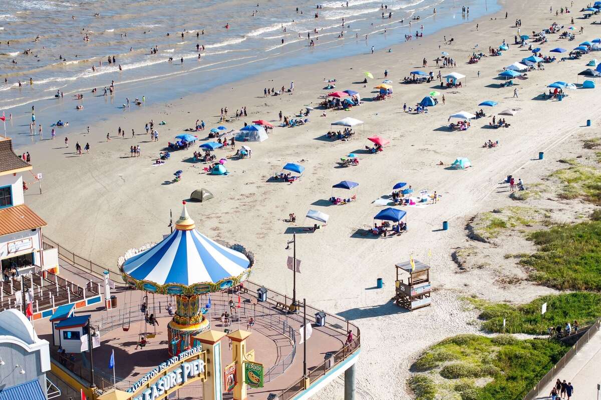 Galveston's beaches, like this one by the Pleasure Pier, are likely to be as crowded over the July 4 weekend as they are all year.