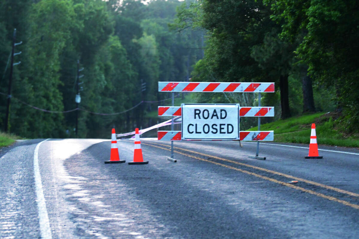 A road closure sign on a flooded Texas road. More floods Saturday left at least seven dead in areas north of Austin, Texas.
