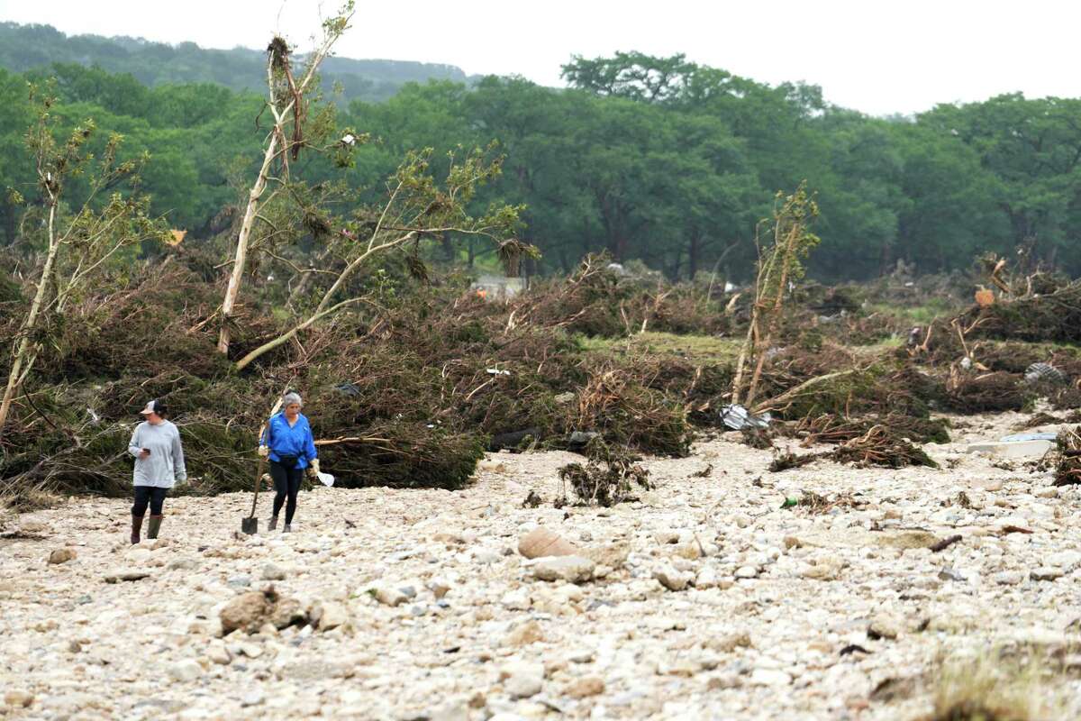 People search for survivors near the Guadalupe River in Hunt, Saturday, July 5, 2025.