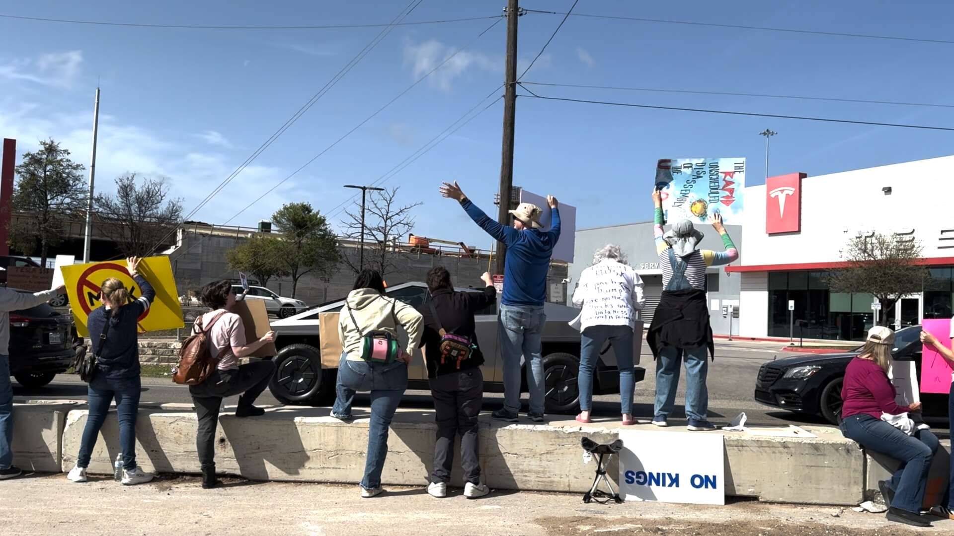 Over 100 protest against Elon Musk outside Austin Tesla showroom