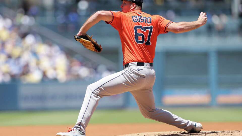 Houston Astros pitcher Ryan Gusto throws to a Los Angeles Dodgers batter during the first inning of a baseball game Sunday, July 6, 2025, in Los Angeles. (AP Photo/Jessie Alcheh)