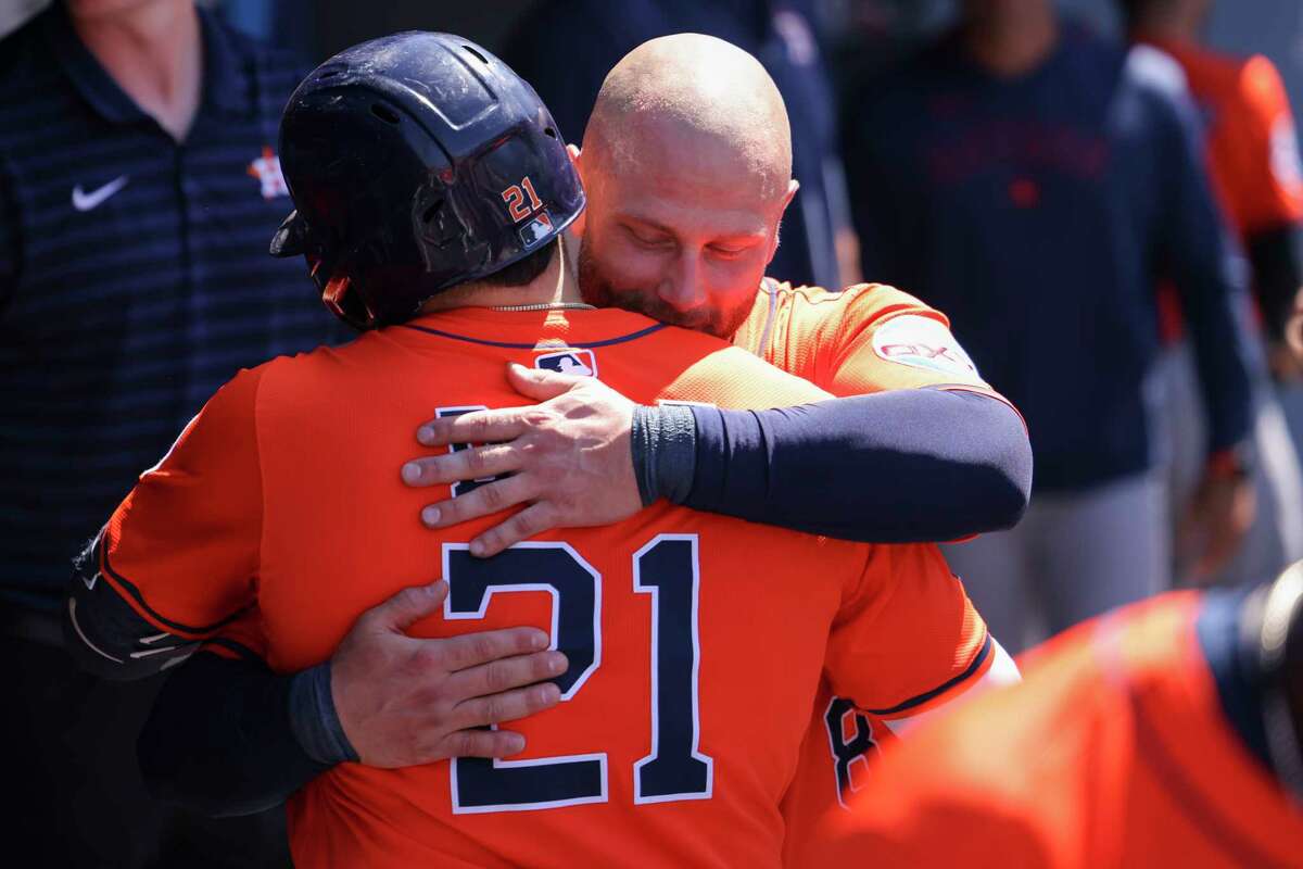 Houston Astros' Yainer Diaz (21) and Christian Walker embrace after Diaz hit a home run during the eighth inning of a baseball game against the Los Angeles Dodgers, Sunday, July 6, 2025, in Los Angeles. (AP Photo/Jessie Alcheh)