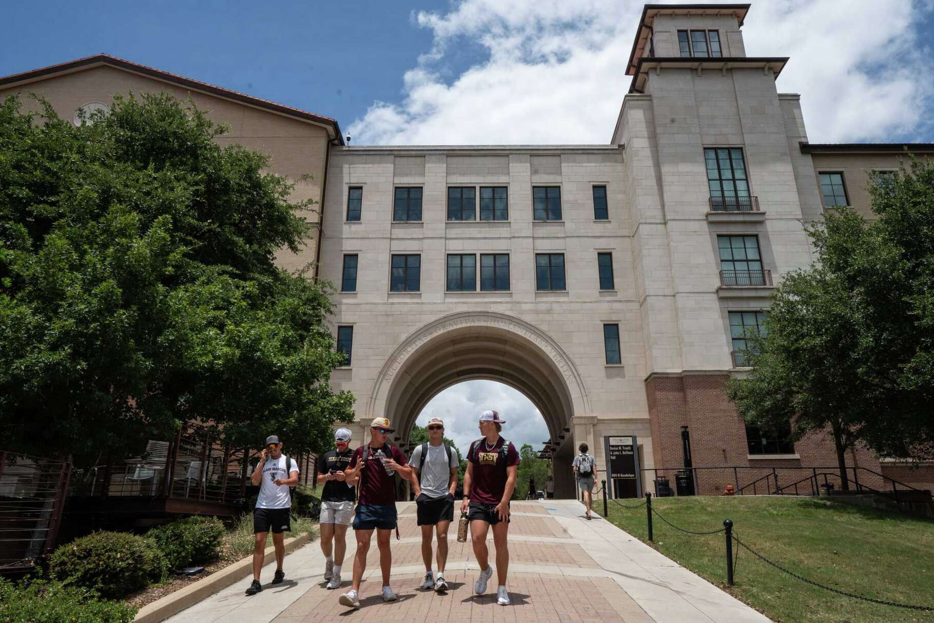 Students walk on campus at Texas State University in San Marcos Monday, June 30, 2025. 