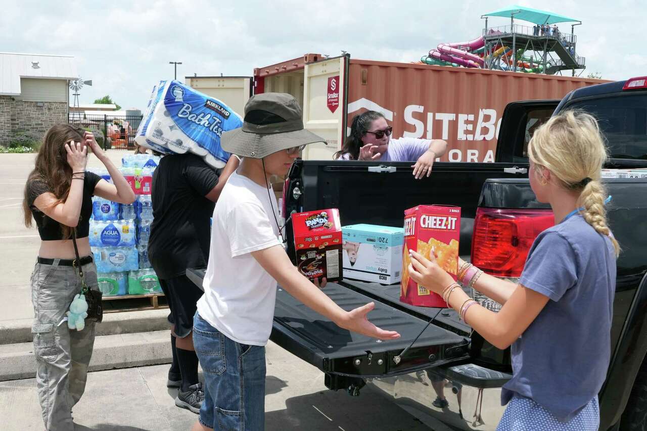 Volunteers help organize supplies at Typhoon Texas donated by community members to support victims of the Guadalupe River flood in Houston, Monday, July 7, 2025.