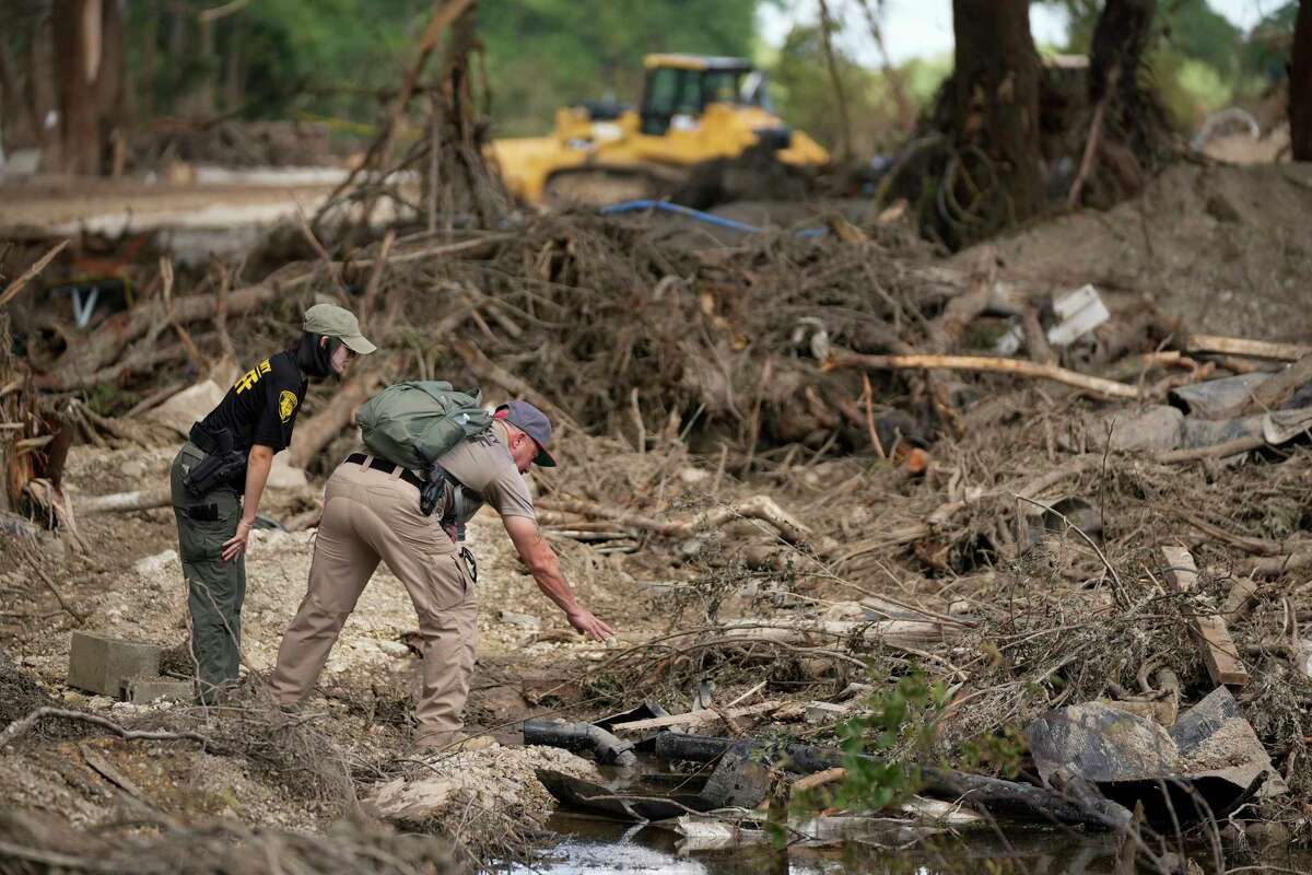 Upton County sheriff deputies do search and recovery work on the banks of the Guadalupe River in Ingram, Tuesday, July 8, 2025, after the Fourth of July flood.
