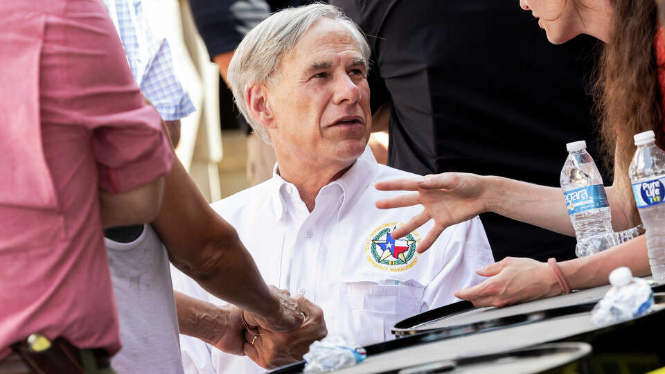 Courtney Calhoun of Hunt addresses Governor Greg Abbott about concerns of volunteers’ efforts being impeded after Abbott gave a press conference at The Hunt Store in Hunt, on Tuesday, July 8, 2025.