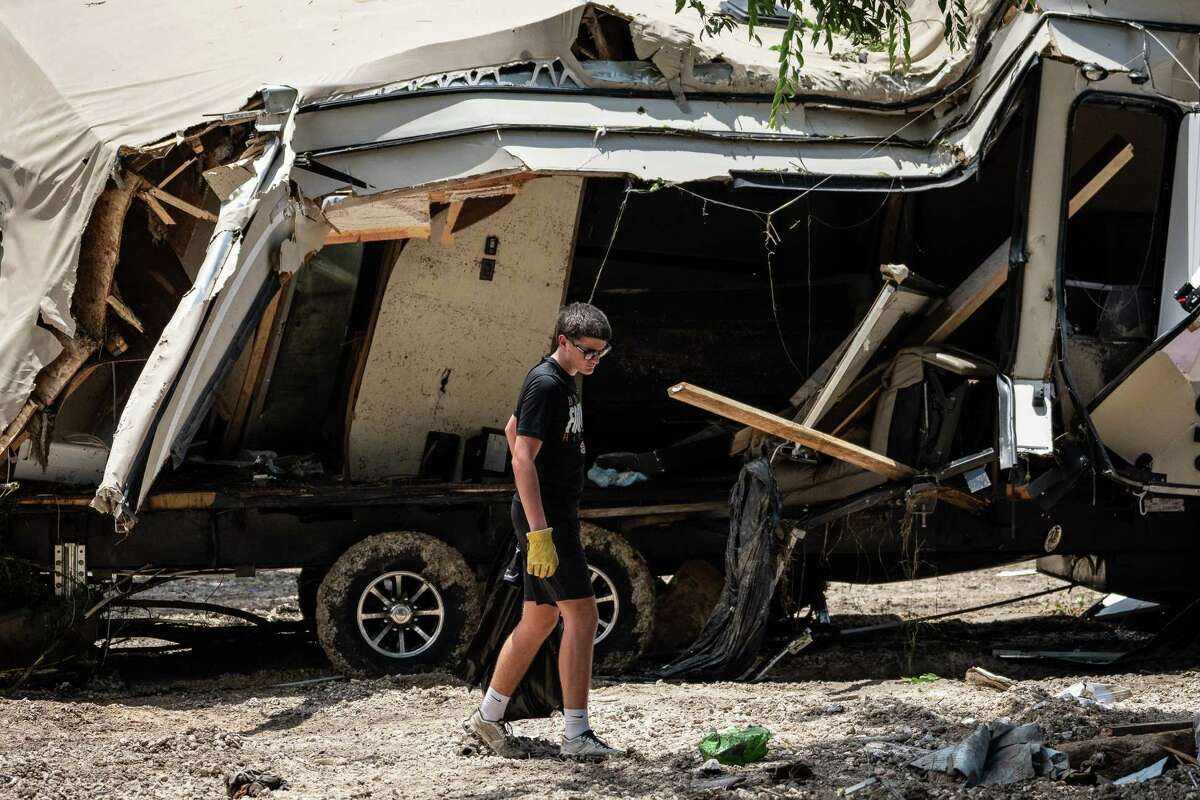 Volunteer Jax Turner works to remove flood debris at GoodWater RV Park near Georgetown, July 9, 2025 after devastating flash flooding swept through the area on July 5.