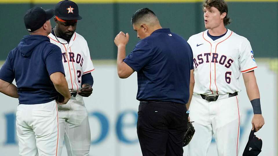 Houston Astros' Jake Meyers (6) talks with manager Joe Espada, left, as Taylor Trammell (26) and a trainer join them before the start a baseball game against the Cleveland Guardians Wednesday, July 9, 2025, in Houston. (AP Photo/David J. Phillip)
