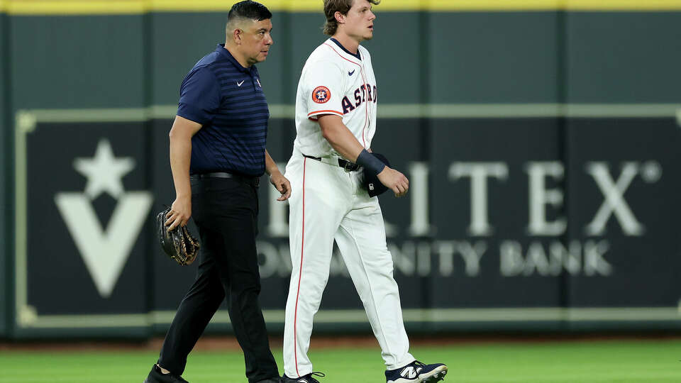 Astros center fielder Jake Meyers leaves the field with assistant athletic trainer Eric Velazquez after his right calf tightened up on him as he took his position before Wednesday's game.