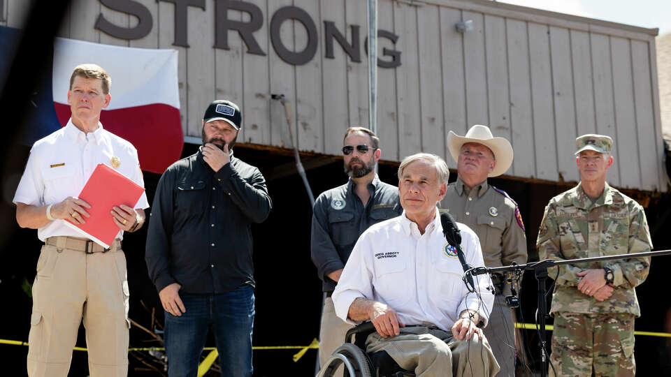 Governor Greg Abbott listens to a community member address him at The Hunt Store in Hunt, on Tuesday, July 8, 2025.