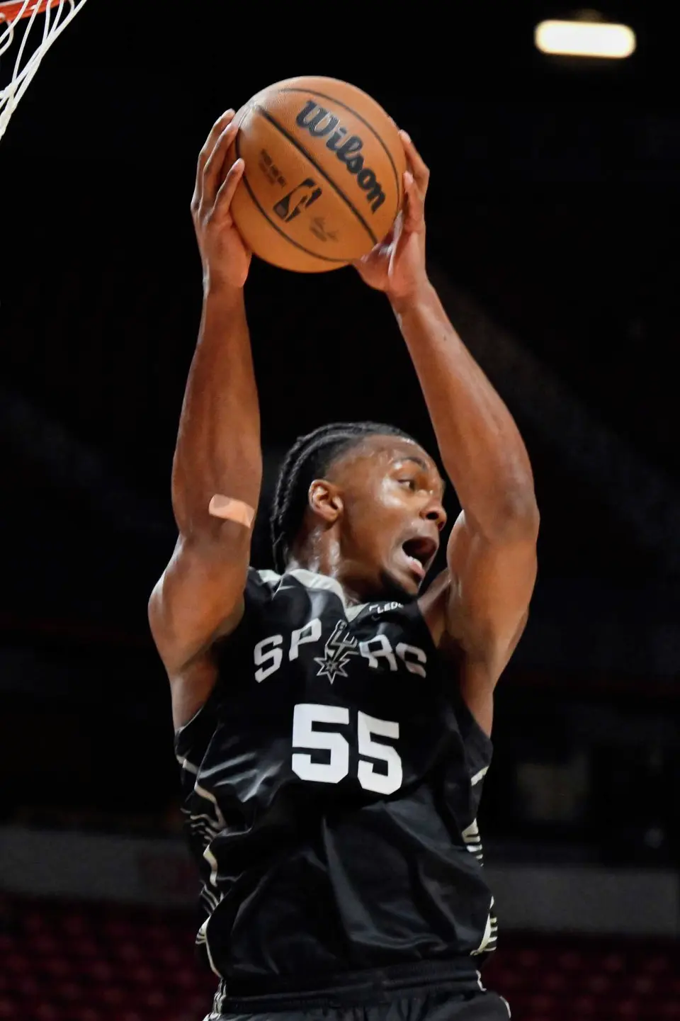 San Antonio Spurs guard Harrison Ingram (55) grabs a rebound against the Philadelphia 76ers during the second half of an NBA summer league basketball game Thursday, July 10, 2025, in Las Vegas. (AP Photo/David Becker)