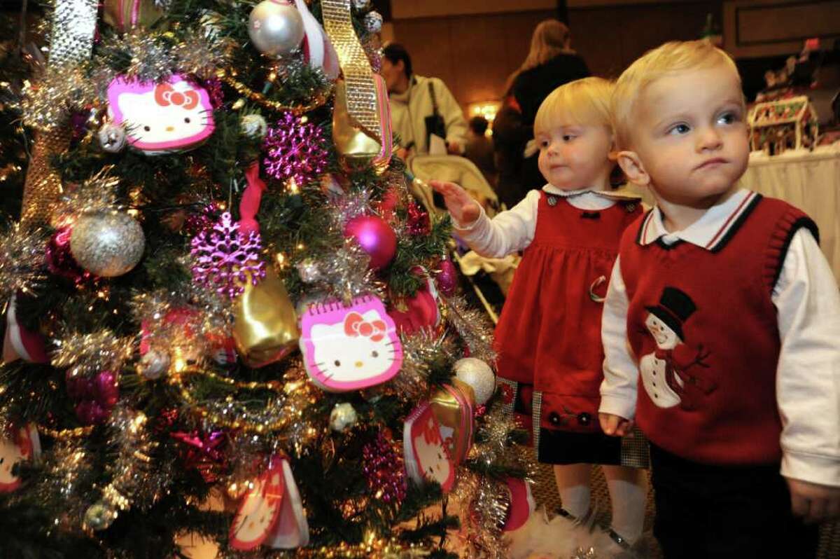 Terra McDonnell, 2, and her friend Christopher DiPreta, 1, both of Greenwich, admire one of the Christmas trees at the Junior League of Greenwich's benefit, "The Enchanted Forest," at the Hyatt Regency Greenwich, on Sunday, Nov. 21, 2010.