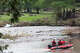 A search and rescue team rides in a boat on the Guadalupe River as they work in Hunt, on Tuesday, July 15, 2025.