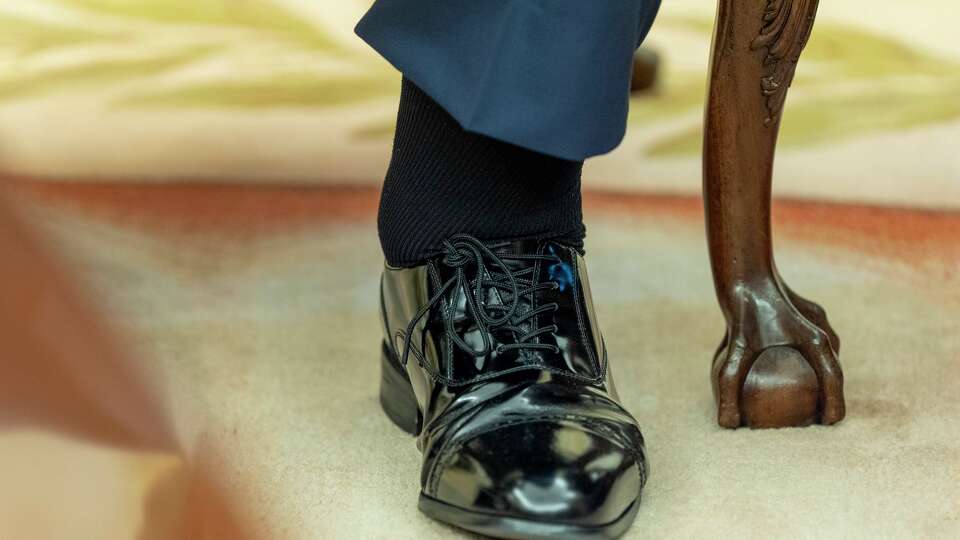 The left foot and swollen ankle of President Donald Trump are pictured as he sits with Bahrain's Crown Prince Salman bin Hamad Al Khalifa in the Oval Office of the White House, Wednesday, July 16, 2025, in Washington.