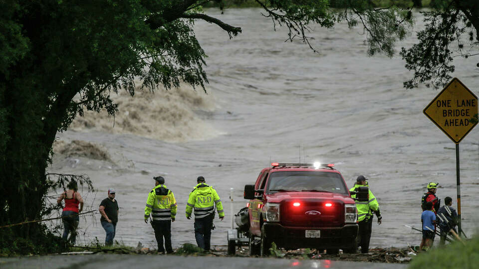 First responders scan the banks of the Guadalupe River in Ingram, TX as rescue efforts to find individuals swept away in early morning flooding on July 4, 2025.