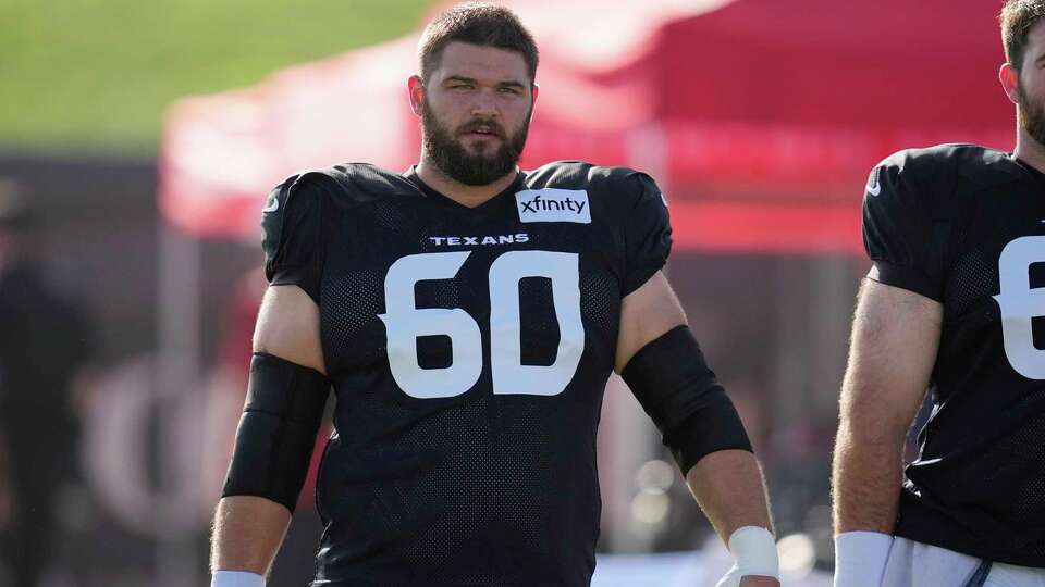 Houston Texans center Jake Andrews (60) walks across the field before an NFL football training camp practice Monday, July 28, 2025, in Houston. (AP Photo/David J. Phillip)