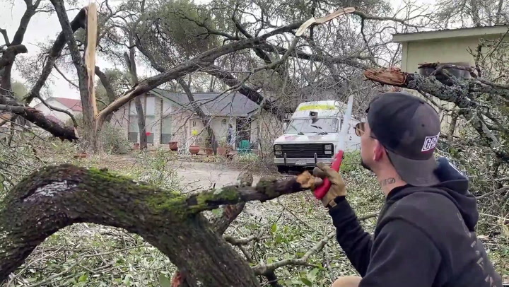 Cleaning up tree debris with a knife after the Austin ice storm