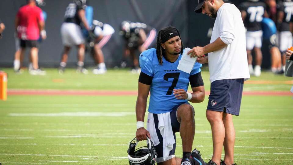 Houston Texans quarterback C.J. Stroud (7) works with offensive coordinator Nick Caley during an NFL training camp practice at Houston Methodist Training Center in Houston, Tuesday, July 29, 2025.