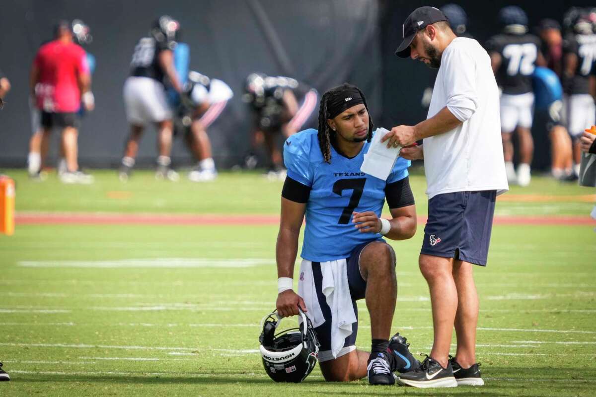 Houston Texans quarterback C.J. Stroud (7) works with offensive coordinator Nick Caley during an NFL training camp practice at Houston Methodist Training Center in Houston, Tuesday, July 29, 2025.