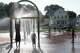 Children keep cool under fountains on a hot afternoon at the water park at City Park in Meriden, Conn., Tuesday, July 29, 2025.