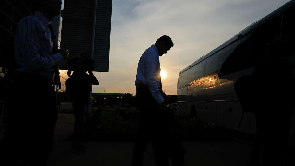 Democratic Texas Rep. Gene Wu is silhouetted by the setting sun as he boards a bus following a press conference with other Texas House Democrats and Democratic members of Congress at the Democratic Party in Warrenville, Ill., Monday, Aug. 4, 2025. (AP Photo/Nam Y. Huh)