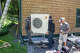 Technicians install part of a heat pump system at a home in Charlotte, Vt., in July. Heat pumps use less energy, and they provide heating and cooling.