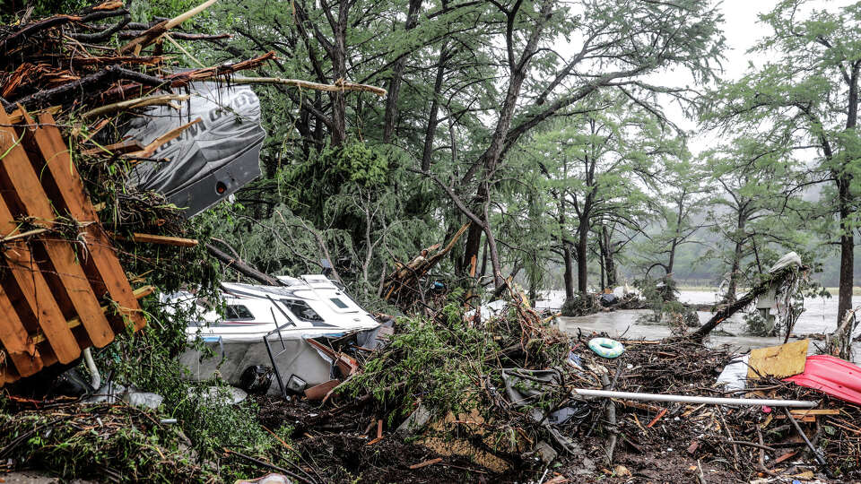 Numerous fecreational vehicles are piled up on the banks of the Guadalupe River in Ingram, TX after being swept away in early morning flooding on July 4, 2025. Two RV parks, just upstream, were stripped of all RV's and buildings leaving nothing but concrete pads.