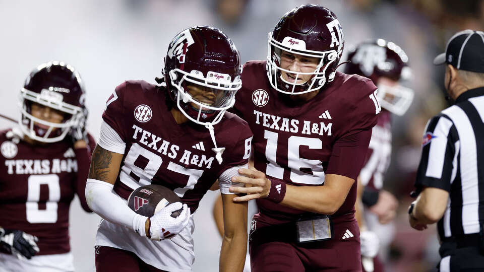 COLLEGE STATION, TEXAS - NOVEMBER 16: Miles O'Neill #16 of the Texas A&M Aggies congratulates Ashton Bethel-Roman #87 after a touchdown in the second half against the New Mexico State Aggies at Kyle Field on November 16, 2024 in College Station. (Photo by Tim Warner/Getty Images)
