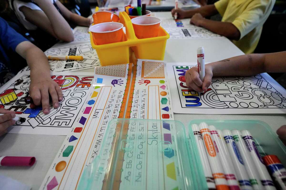 First graders color a worksheet on the first day of school at Conroe ISD’s Eissler Elementary School in Conroe, Wednesday, Aug. 13, 2025.