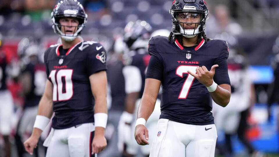 Houston Texans quarterbacks Davis Mills (10) and C.J. Stroud warm up before a preseason NFL football game against the Carolina Panthers at NRG Stadium in Houston, Saturday, Aug. 16, 2025.