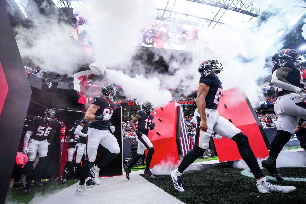 Houston Texans players run onto the field as they are introduced before a preseason NFL football game against the Carolina Panthers at NRG Stadium in Houston, Saturday, Aug. 16, 2025.