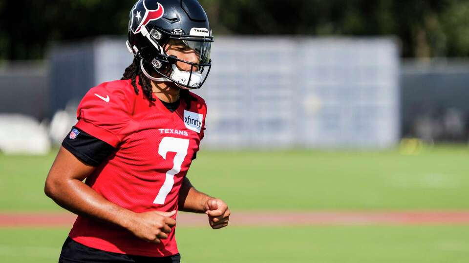 Houston Texans quarterback C.J. Stroud jogs to the field during an NFL training camp practice at Houston Methodist Training Center in Houston, Wednesday, Aug. 20, 2025.