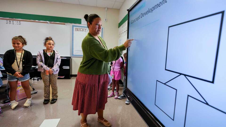 Luz Aguilar works with her first graders at Cypresswood Elementary in Aldine ISD in Houston, Wednesday, Aug. 20, 2025. Aldine ISD is one of the most improved school districts in the Houston area in 2025 TEA A-F ratings, increasing the district's overall score by 10 points in two years.
